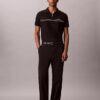 Tricou polo cu fermoar pe un sfert și bordură contrastantă