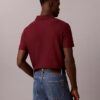 Tricou polo cu fermoar pe un sfert și bordură contrastantă