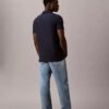 Tricou polo cu fermoar pe un sfert și bordură contrastantă
